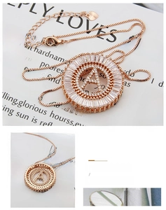 Detail of rose gold A-letter pendant with cubic zirconia inlay and box chain necklace