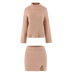 Detailed texture of dusty pink ribbed knit turtleneck sweater and matching mini skirt set