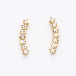 Detail of gold ear climbers with seven graduated round cubic zirconia stones in prong setting