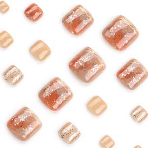 Caramel amber press-on toenails with silver glitter and jelly texture on white background