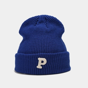 Detail shot of blue ribbed knit beanie featuring a white towel-textured P embroidery