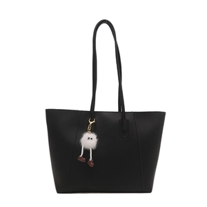 Minimalist black PU leather tote bag with creative plush doll charm on white background