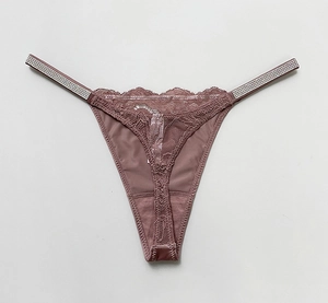 Detailed view of mauve lace thong featuring sparkling rhinestone straps and silk panel