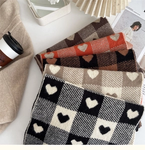 A neatly arranged variety of colors for the knitted checkered heart patterned scarves