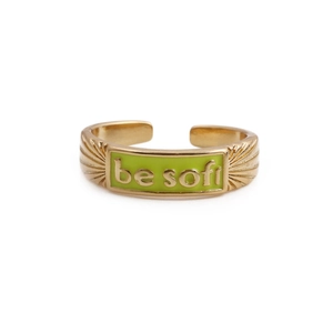 Detail of gold letter ring with green enamel inlay featuring a be soft engraving on band