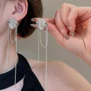 Detail of silver irregular rose stud earrings with long beaded tassel chains