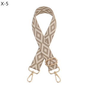 Detail of beige and khaki geometric diamond pattern strap with gold metal swivels