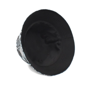 Detail of printed bucket hat showing reinforced stitching on brim and black inner lining