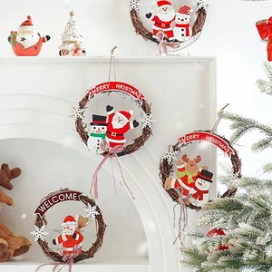 Christmas rattan wreath with Santa and snowman dolls on a mantelpiece setting