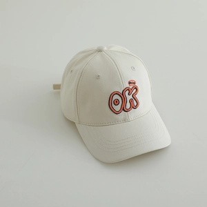 Detailed close-up of orange OK embroidery on a cream cotton baseball cap for kids
