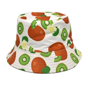 Detail of white bucket hat with green kiwi fruit print and floral patterns on cotton fabric