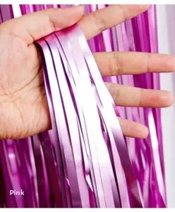 Detail shot of shimmering pink tinsel fringe curtain showing soft metallic foil texture