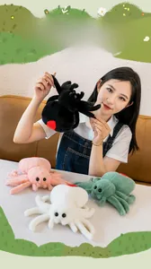 Detail showing plush spiders in black, pink, white, and green with soft faux fur texture