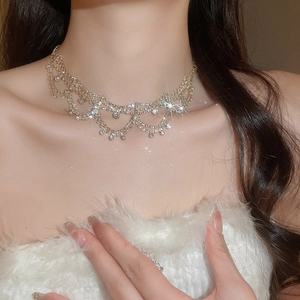 Close-up of luxury gold multi-layer rhinestone floral necklace worn by a model