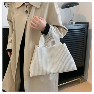 Close-up of cream corduroy tote bag showing thick ribbed texture and fabric detail