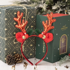 Detail of red sequined reindeer antlers headband with festive bells and mushroom ornaments