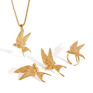 Polished gold stainless steel jewelry set featuring detailed peace bird pendant and ring