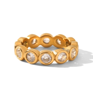 Detail of gold bezel set eternity ring with white round cubic zirconia stones