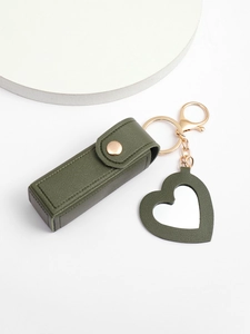 Close-up of military green leather lipstick case with heart mirror and gold hardware