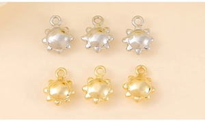 Detailed view of sun-shaped jewelry charms in gold and silver plating for DIY projects