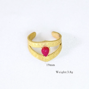 Detail view of 14k gold plated ring with pear shaped pink gemstone and V-shaped band