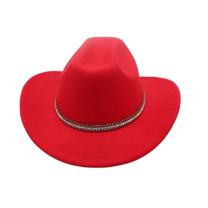 Detail of red felt cowboy hat featuring a brown band with studs and rhinestones