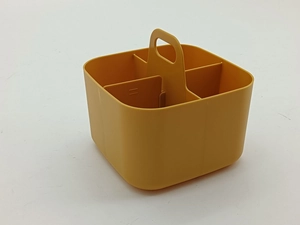 Macro view of a yellow plastic organizer basket featuring four compartments and a handle