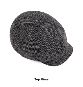 Top view of classic newsboy cap featuring black and gray herringbone wool fabric texture