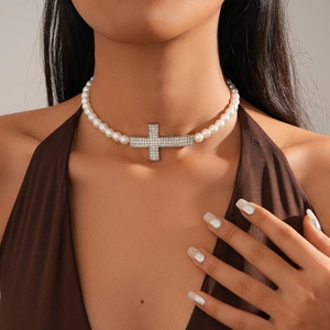 Baroque style pearl choker with a sparkling diamond-encrusted silver cross pendant for women