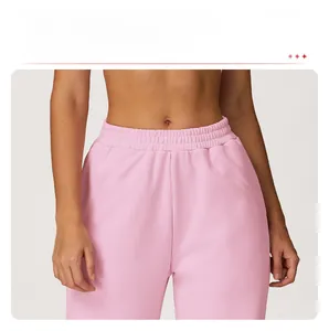 Detail of high-waist pink sweatpants featuring a flexible elastic waistband for comfort