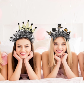 Detail view of 2025 New Year party headbands with festive tinsel and crown decor