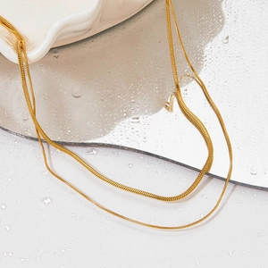 Double-layered gold snake chain necklace featuring a minimalist polished stainless steel finish