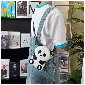 Toddler modeling a cute panda crossbody bag with a patterned strap and a silicone finish