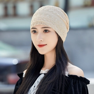 Close-up of beige lace beanie cap featuring breathable fabric and subtle sequin detailing