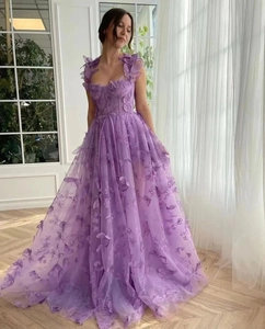 Detail of 3D butterfly embroidery on lavender tulle evening gown with pleated waist