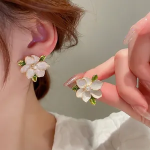 Exquisite flower stud earrings with white petals and green leaves for elegant women