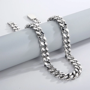 Close-up of polished silver titanium steel Cuban link chain with square clasp on display