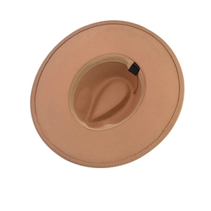 Detail view of camel wool fedora hat interior with sweatband and black woven fabric label