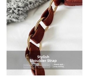Detail of a brown matte leather shoulder strap with golden metal rings and texture