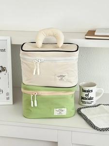 Large nylon cosmetic bags in beige and green colors with crescent handles and dual zippers