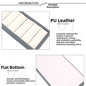 Detail of grey PU leather jewelry tray with white microfiber lining, waterproof material
