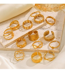 Detailed view of 13 gold-plated rings set on stone with vintage and modern textures
