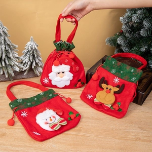 Three Christmas gift bags with Santa, snowman and reindeer designs in a festive setting