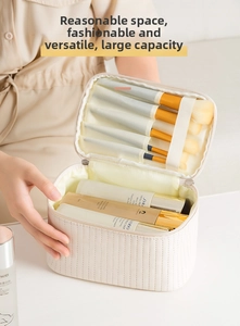 Detail view of the spacious inner compartments and makeup brush slots in a beige quilted bag