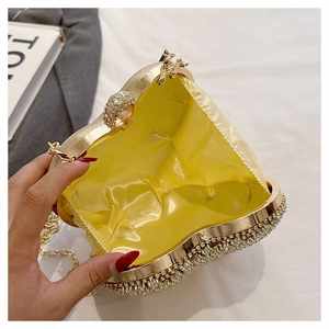 Detail of gold rhinestone heart clutch with yellow satin lining and ring clasp