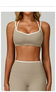 Linen color sports bra with white contrast trim and crossover back detail shown on model
