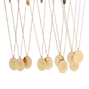 Polished 18K gold plated stainless steel necklaces with various floral patterns on round pendants