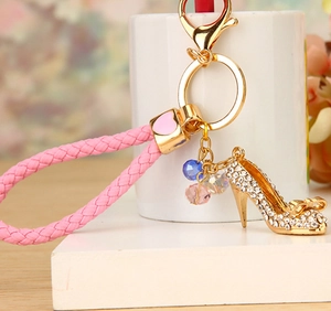 Detail of crystal high heel keychain with pink woven strap and colorful beads