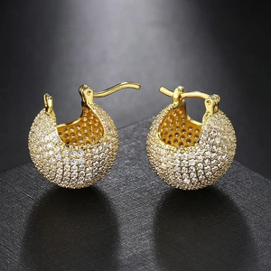 Macro shot of gold-plated spherical hoop earrings with full pave cubic zirconia