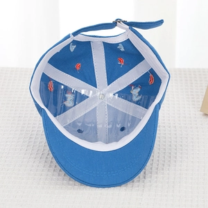 Detail view of cotton baseball cap interior showing white tape and adjustable metal buckle